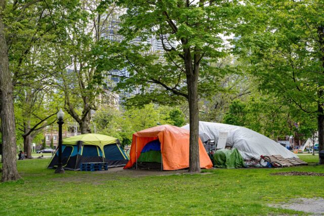 photo - homeless encampment tents in a park