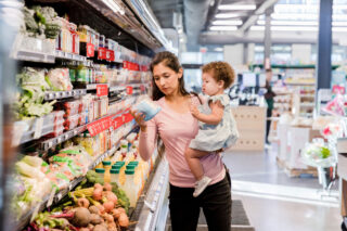 photo - Mother grocery shopping with child
