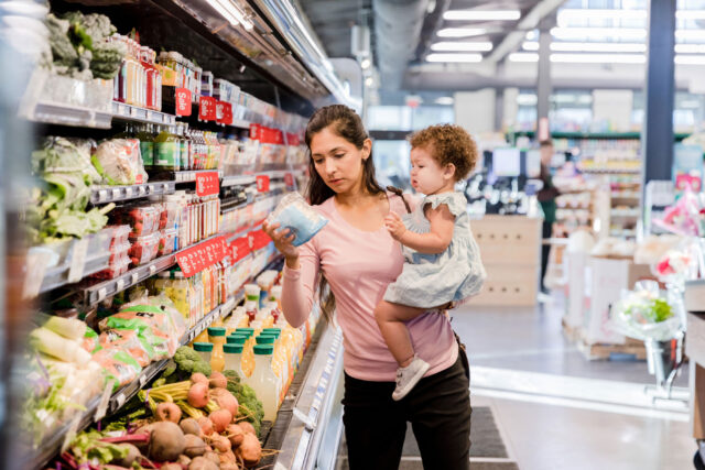 photo - Mother grocery shopping with child
