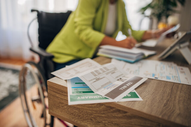 photo - Woman in Wheelchair Doing Home Finances