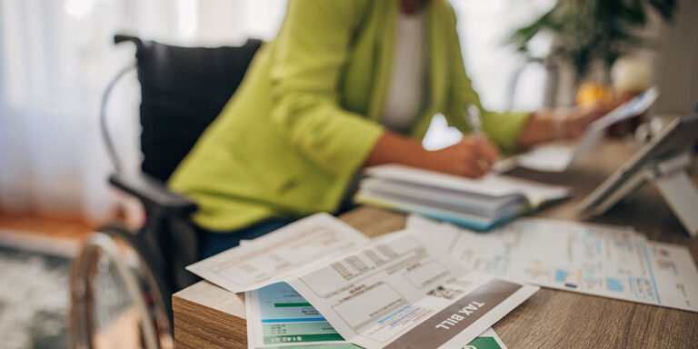 photo - Woman in Wheelchair Doing Home Finances