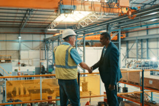 photo - Business People at an Industrial Workshop Handshake at a Factory