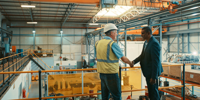 photo - Business People at an Industrial Workshop Handshake at a Factory
