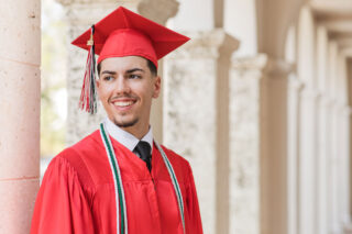 photo - High School Senior in Red Graduation Cap and Gown
