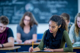 photo - High School Students taking an Exam in Their Classroom