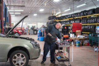photo - Auto Mechanic Working on a Car in a Repair Shop