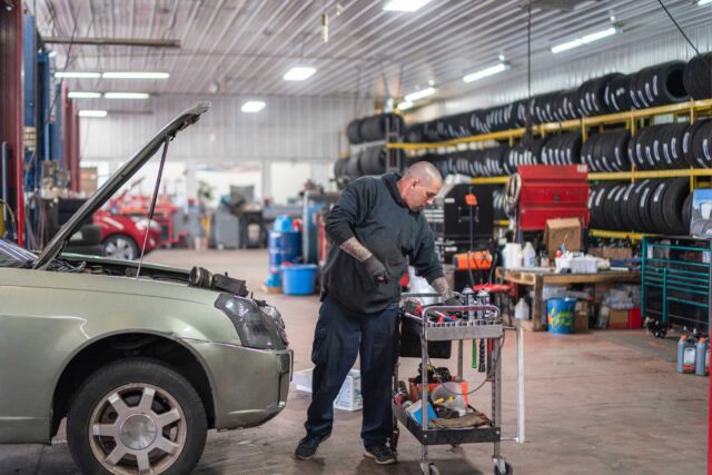 photo - Auto Mechanic Working on a Car in a Repair Shop