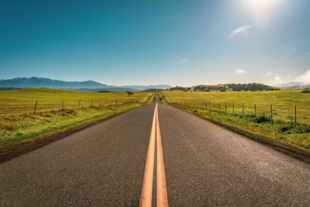 photo - Long Road through Solvang California with Mountains in Background