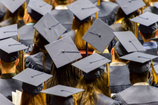 photo - Mortarboard Wearing College Graduates at Commencement Ceremony