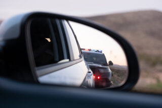 photo - Police Traffic Stop in Rear View Mirror