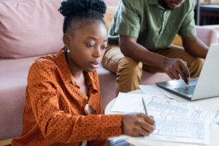 photo - Young Woman Doing Taxes