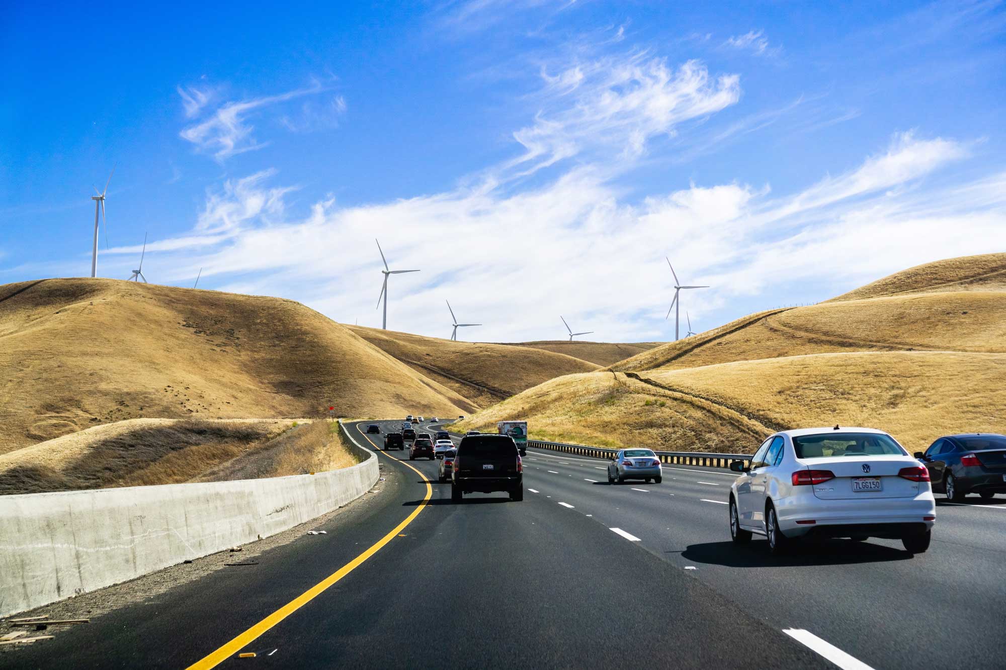 photo - Cars heading towards Altamont Pass in East San Francisco Bay Area with Wind Turbines Visible on Dry Grass Hills
