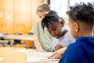photo - Children Reading Together in Elementary Classroom during Collaborative Learning Activity