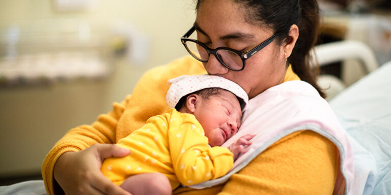 photo - Mother Holding Newborn Baby at Hospital