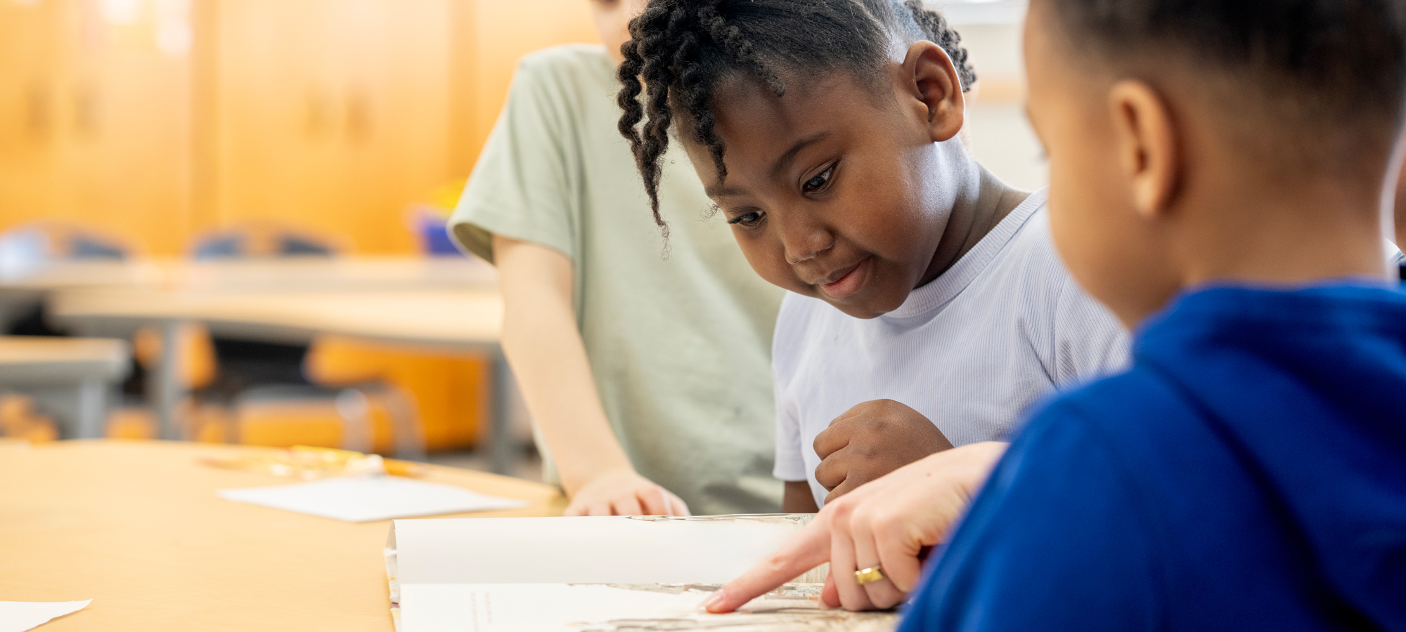 photo - Children Reading Together in Elementary Classroom during Collaborative Learning Activity