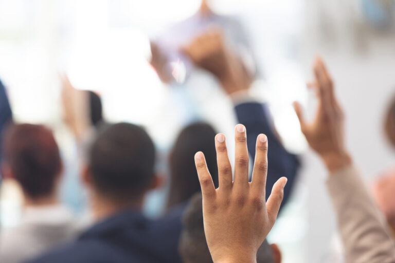 photo - Peoples Hands Up in the Air Waiting To Be Called On