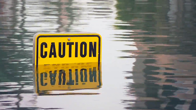 Photo of a street sign in water from flood