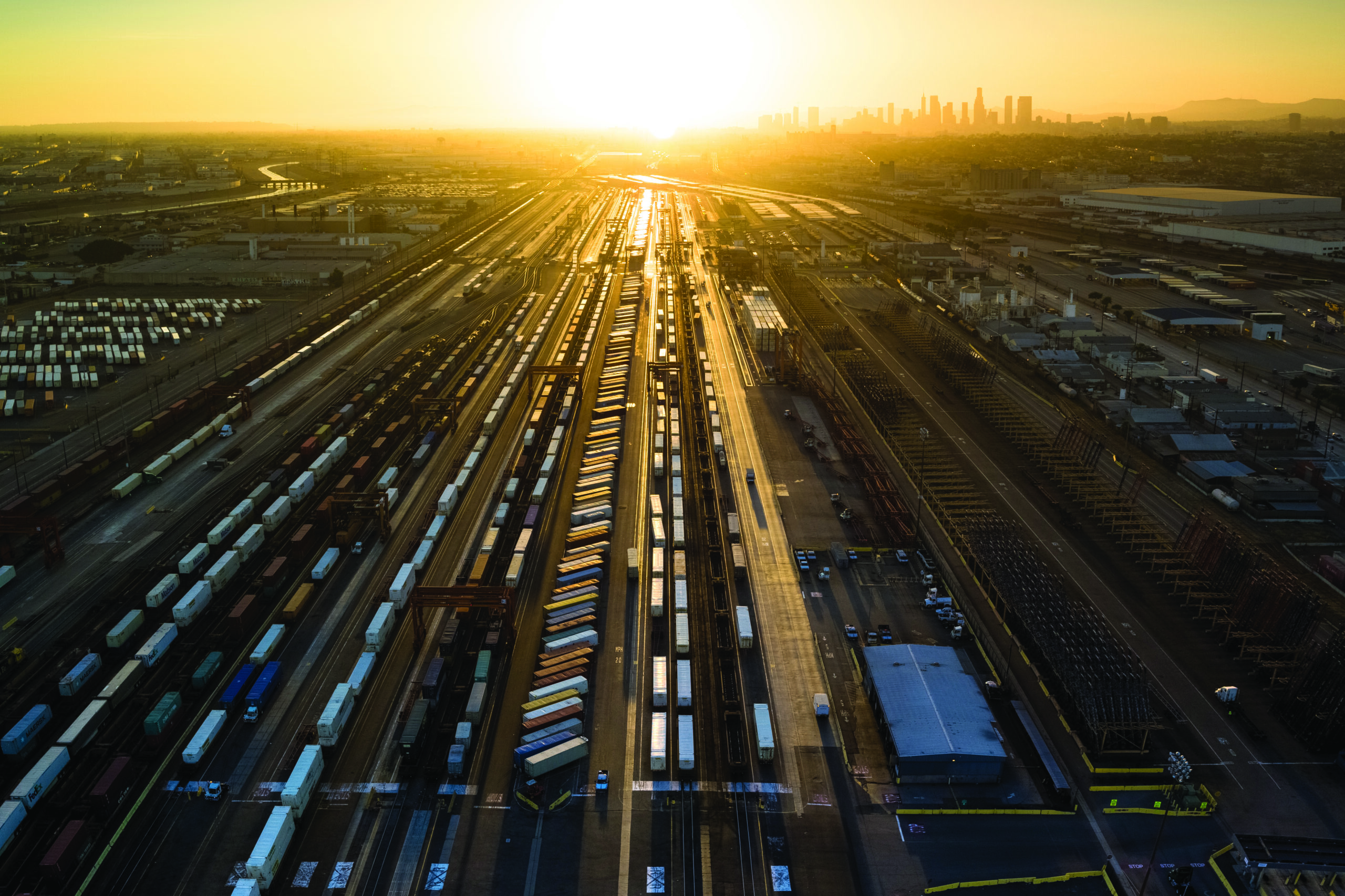 Freight train tracks heading into sunset