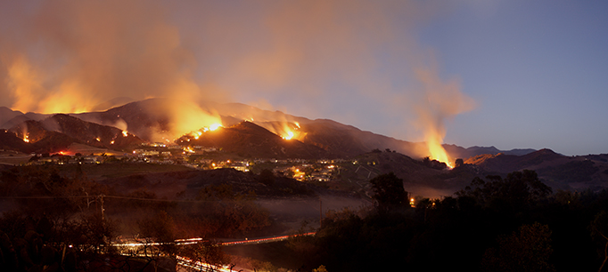 photo: A collection of fires burning across the hillside near homes In Portola Hills, California.
