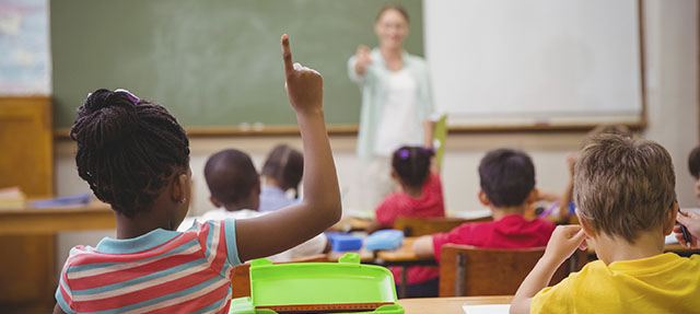 photo - Students Raising-Hand-in a Classroom