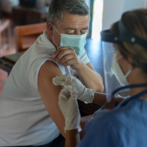 photo - Adult Man Getting a COVID-19 Vaccine at His Rural House