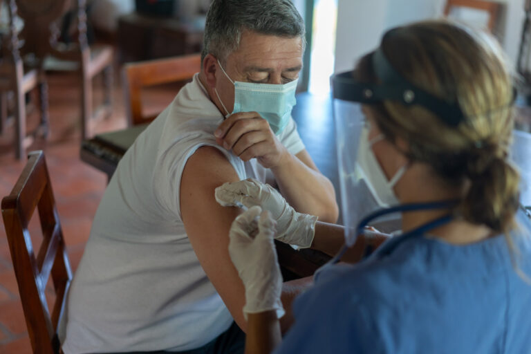 photo - Adult Man Getting a COVID-19 Vaccine at His Rural House
