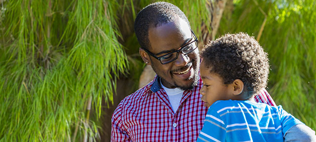 photo - African-American Father Holding Young Son