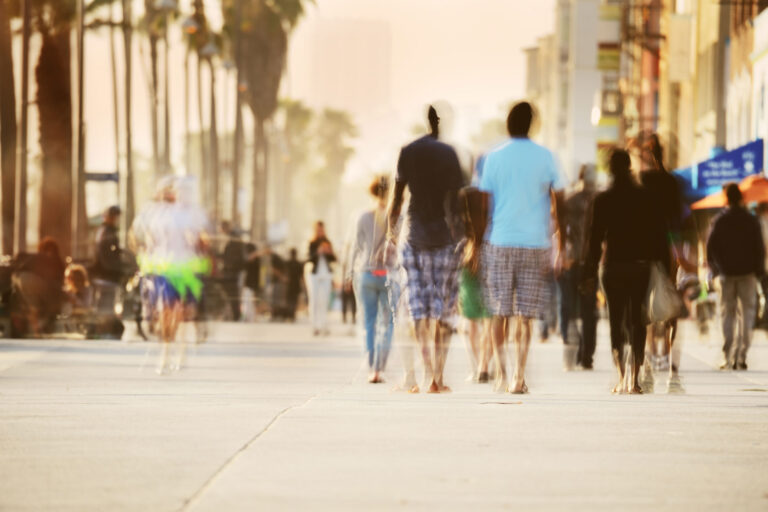 photo - Blurred Pedestrians Walking on Venice Beach Boardwalk