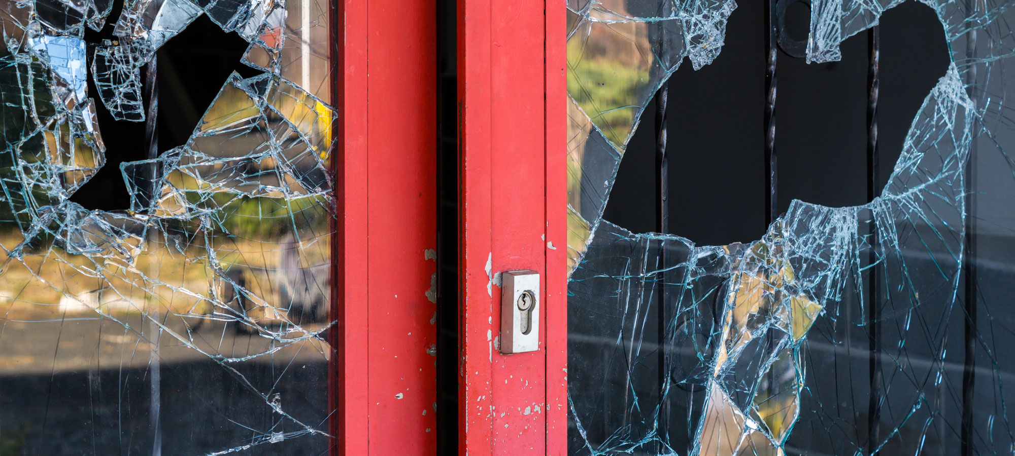 photo - Broken Windowpane and Red Doors