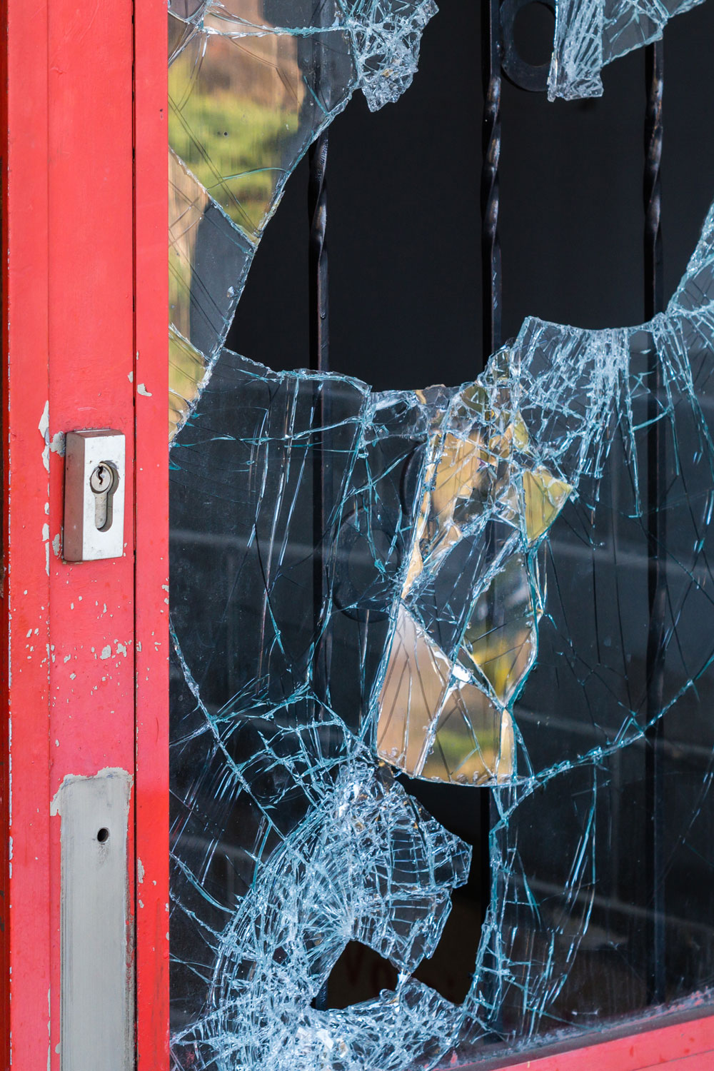 photo - Broken Windowpane and Red Doors