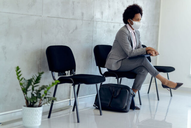 photo - Woman Wearing Mask and Waiting for a Job Interview