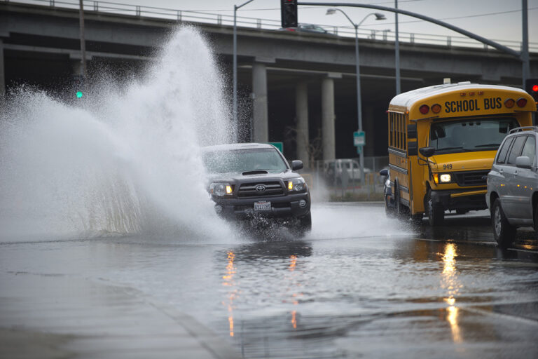 photo - Car Driving thru Flood