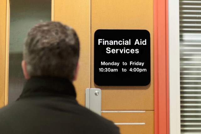 photo - man walking into a financial aid office