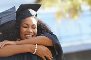 Photo of college graduates hugging