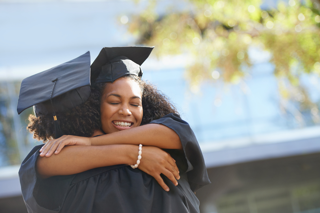 photo - college graduates hugging