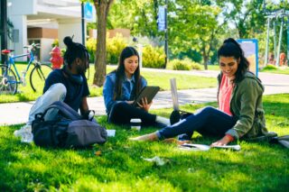 photo - College Students Sitting Together Outside on Campus