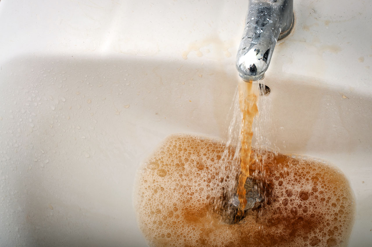 photo - Dirty Brown Water Running from a Filthy Faucet