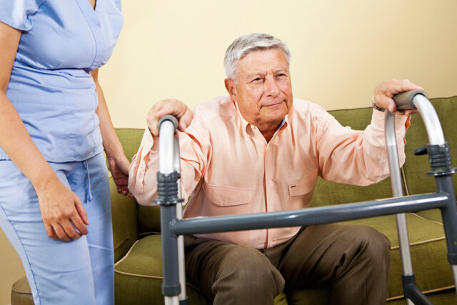 Photo of an elderly man with caregiver