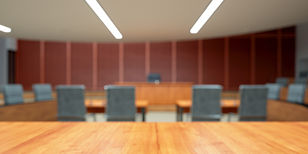 photo - Empty Courtroom Interior with Wooden Desk and Blurred Background
