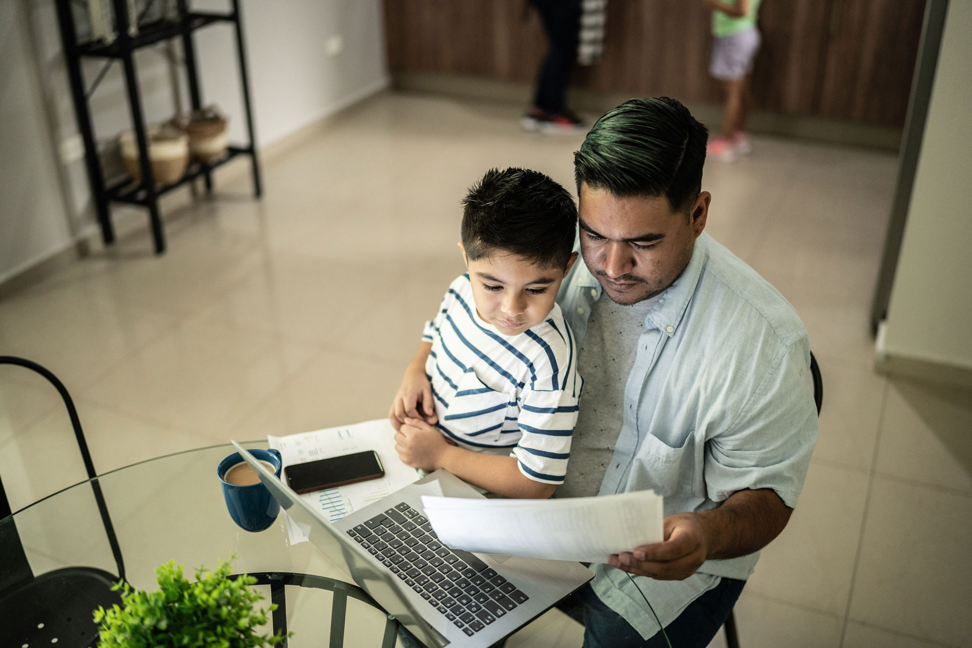 photo - Father Doing Financial Paperwork with Son on Lap