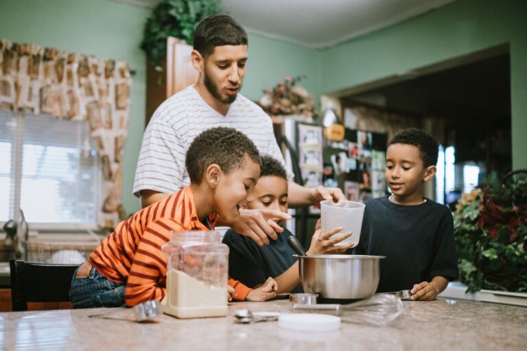 photo - Father Preparing Meal with Sons in Kitchen