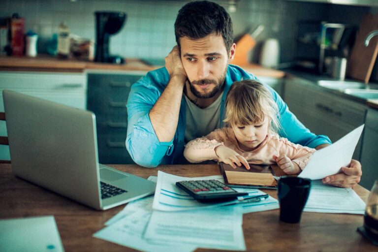 photo - Father with Daughter Looking Over Financial Paperwork