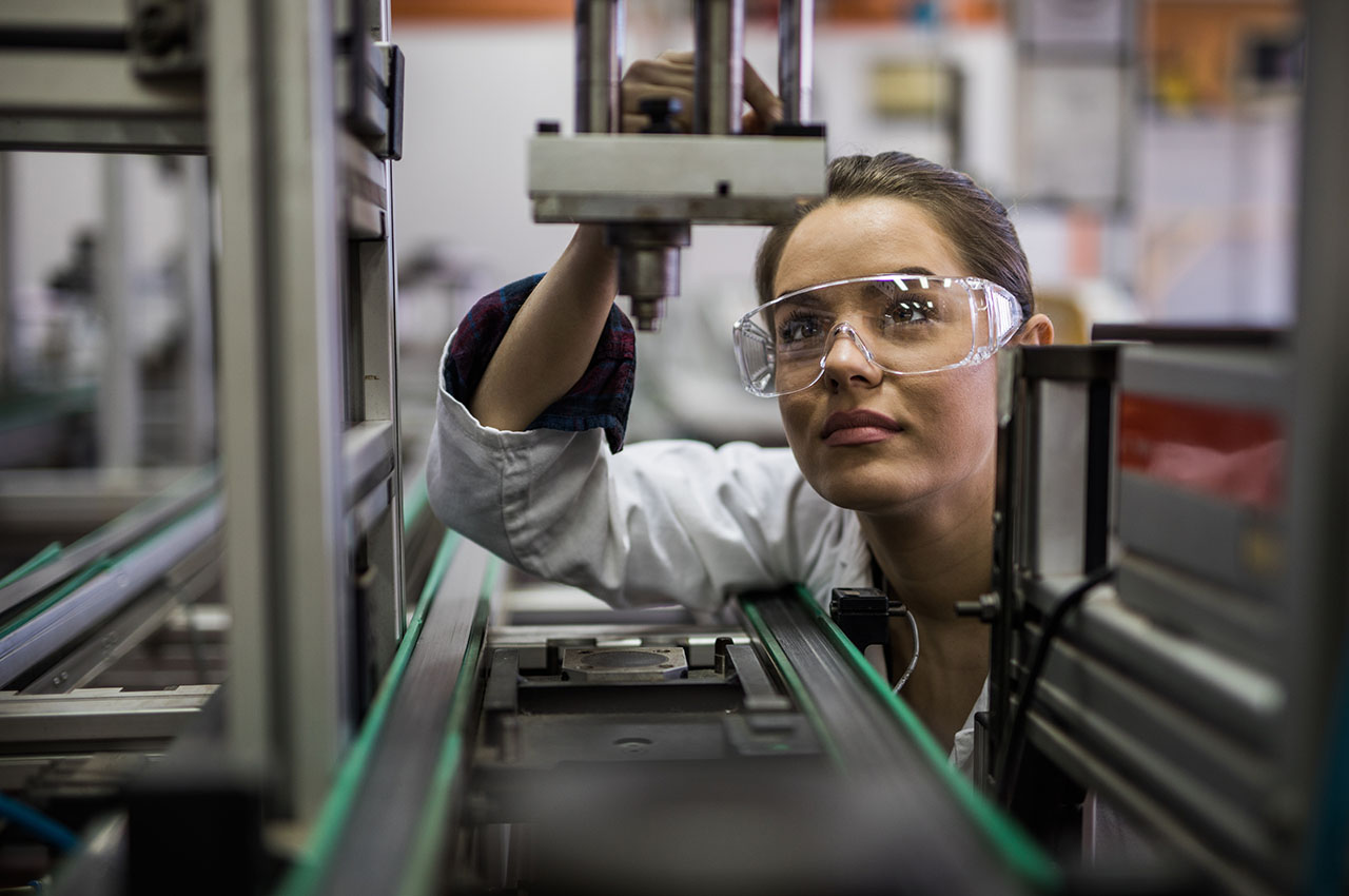 photo - Female Engineer Examining a Machine