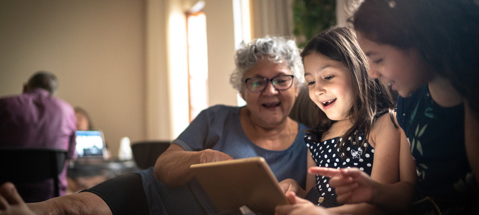 photo - Grandmother and Granddaughter on a Video Call with a Digital Tablet