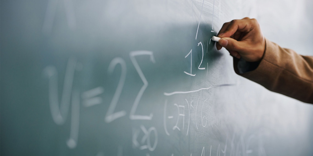 photo - Hand Writing Math on Blackboard