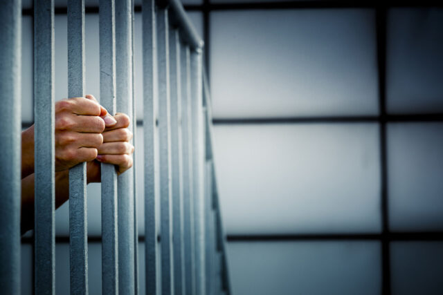 photo - Prisoner Hands on Jail Bars