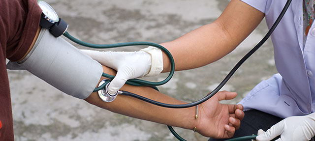 photo - Health Professional Checking Blood Pressure