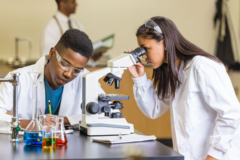 photo - High School Students Using Microscope in Science Class