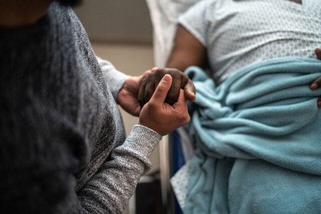 Photo - Holding Hands in Hospital