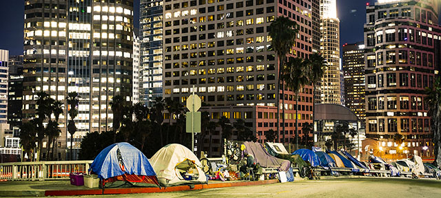 photo - Homeless Tents Beside Skyscrapers in Los Angeles Downtown at Night
